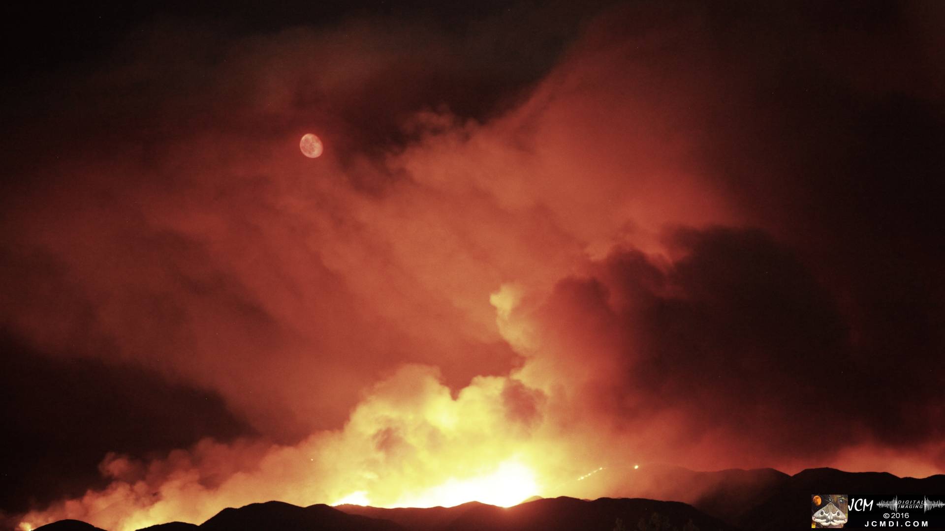 Sand fire long-exposure night image with bloody moonrise JCMDI.COM